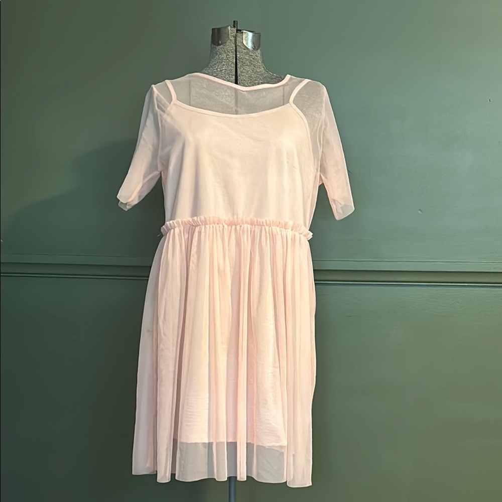 Light pink sheer babydoll dress with ruffle waistline.